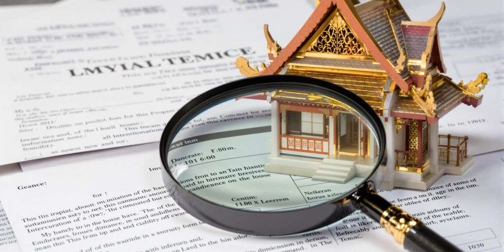 Thai house with legal documents and a magnifying glass.