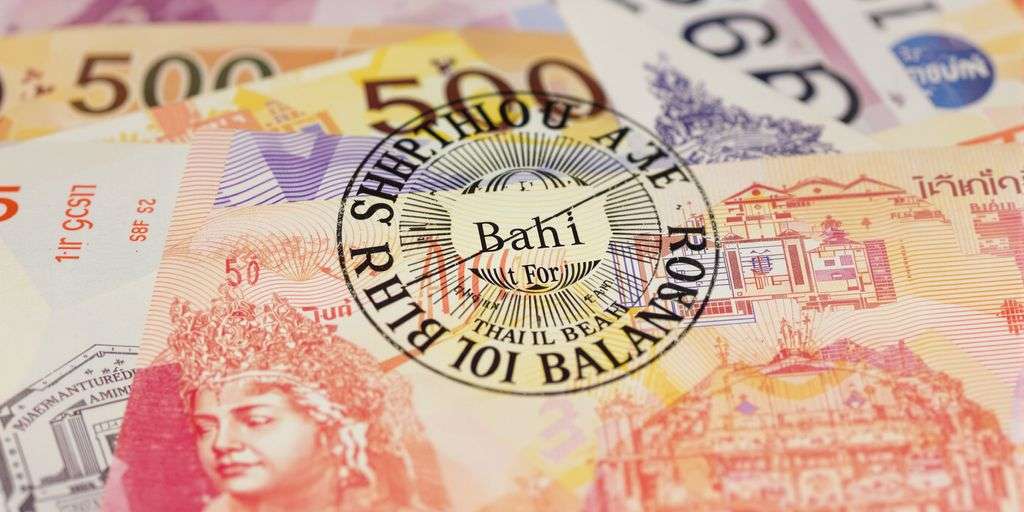 Thai baht banknotes and a stamp.