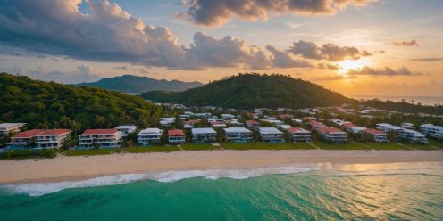 Luxurious Phuket beachfront properties at sunset aerial view.