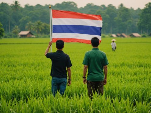 Thai farmers working in a green field with flag