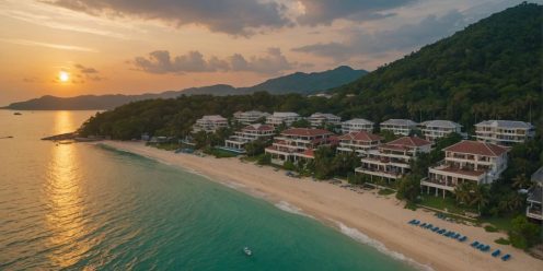 Luxurious Phuket beachfront properties at sunset aerial view.
