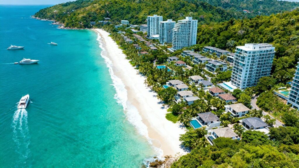 Phuket coastline with luxury villas and turquoise sea.
