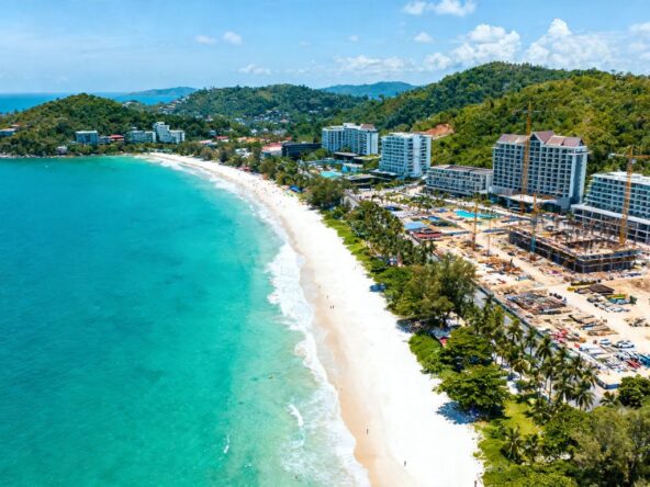 Phuket coastline with resorts and construction, indicating investment boom.