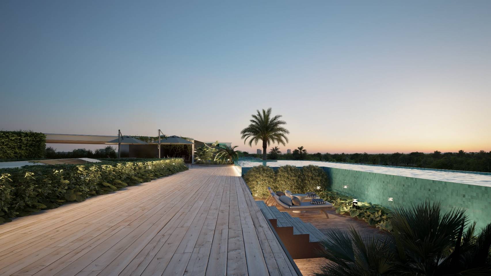 Sunset view over a luxurious rooftop pool area with palm trees, a wooden deck, and lounge chairs.