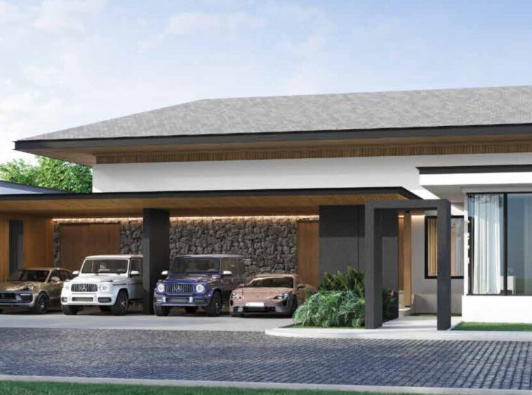Modern single-story house with a wide carport housing multiple luxury cars, stone accent wall, and a large glass-front living space with sheer curtains.