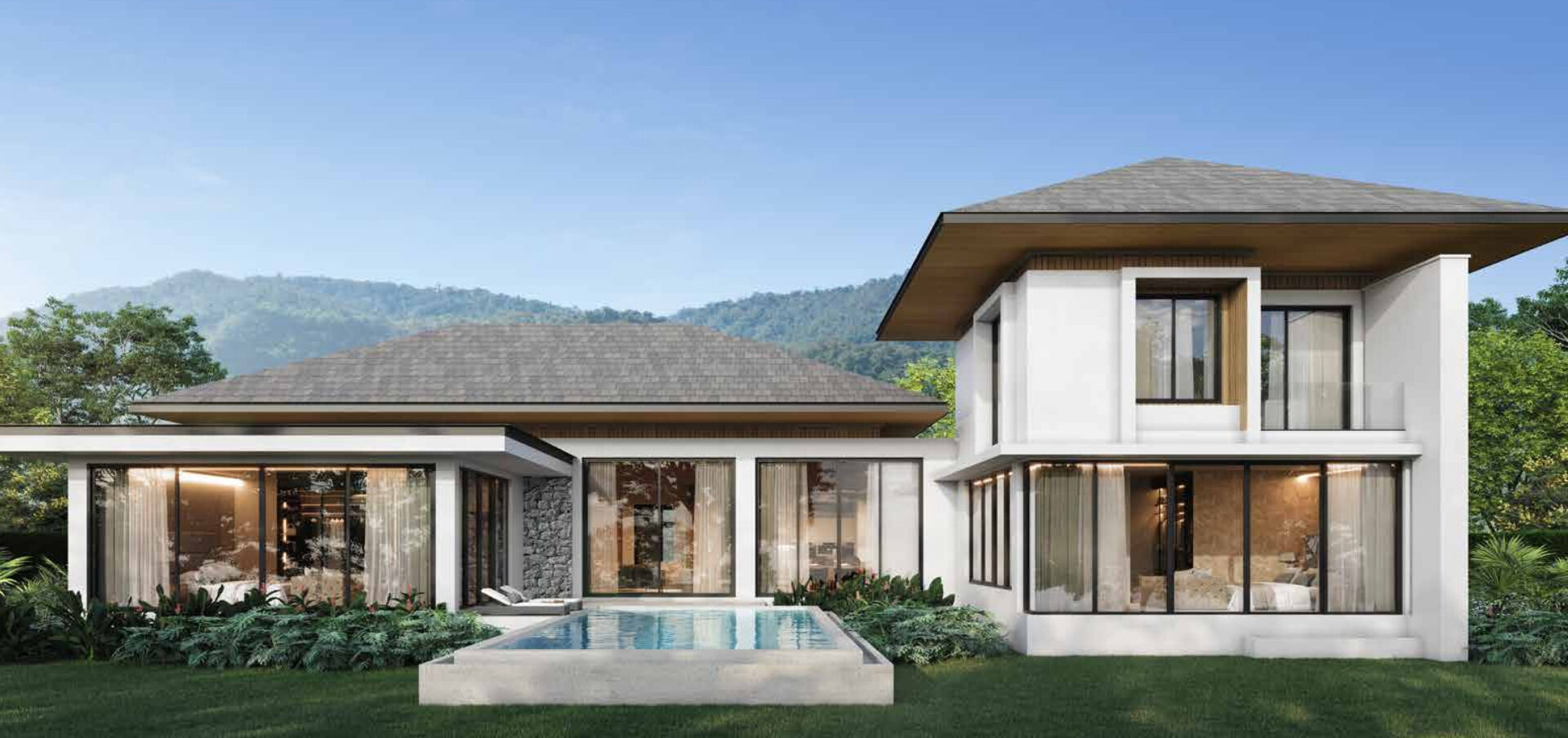 Contemporary white two-story house with large glass walls, a rectangular pool, and a landscaped lawn against a mountainous backdrop