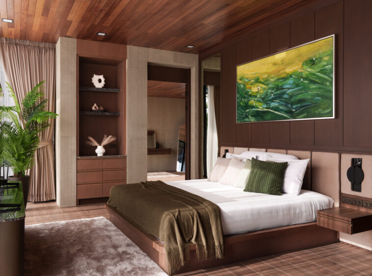 Luxurious bedroom with dark wood paneling, a large bed with white linens and green throw pillows, and a green-yellow abstract painting overheadon the wall.