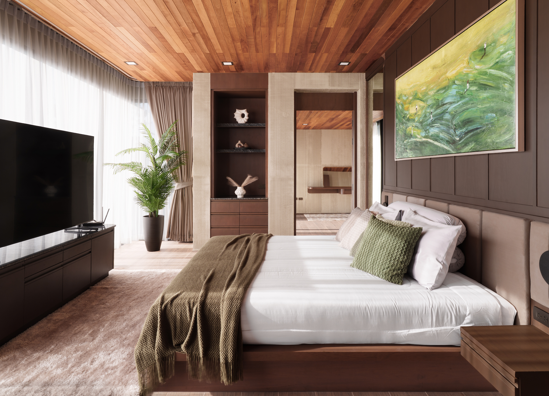 Hotel bedroom with a low wood platform bed, green throw pillows, and a large abstract painting on a brown paneled wall.