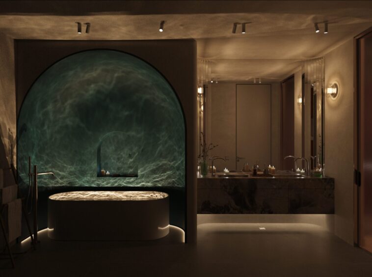 Dimly lit luxury bathroom with a large circular tub in a teal-green alcove, candlelight around the tub, and a marble vanity with double sinks along mirrored walls.