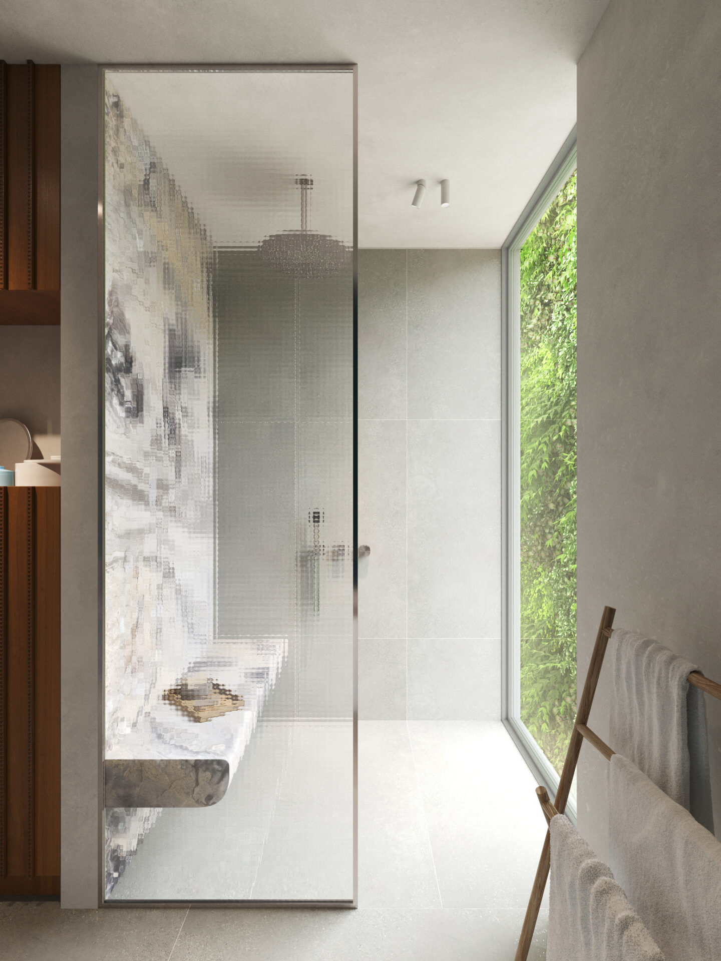 Modern bathroom with a glass shower door, grey tiled walls, and a large window overlooking greenery to the right.