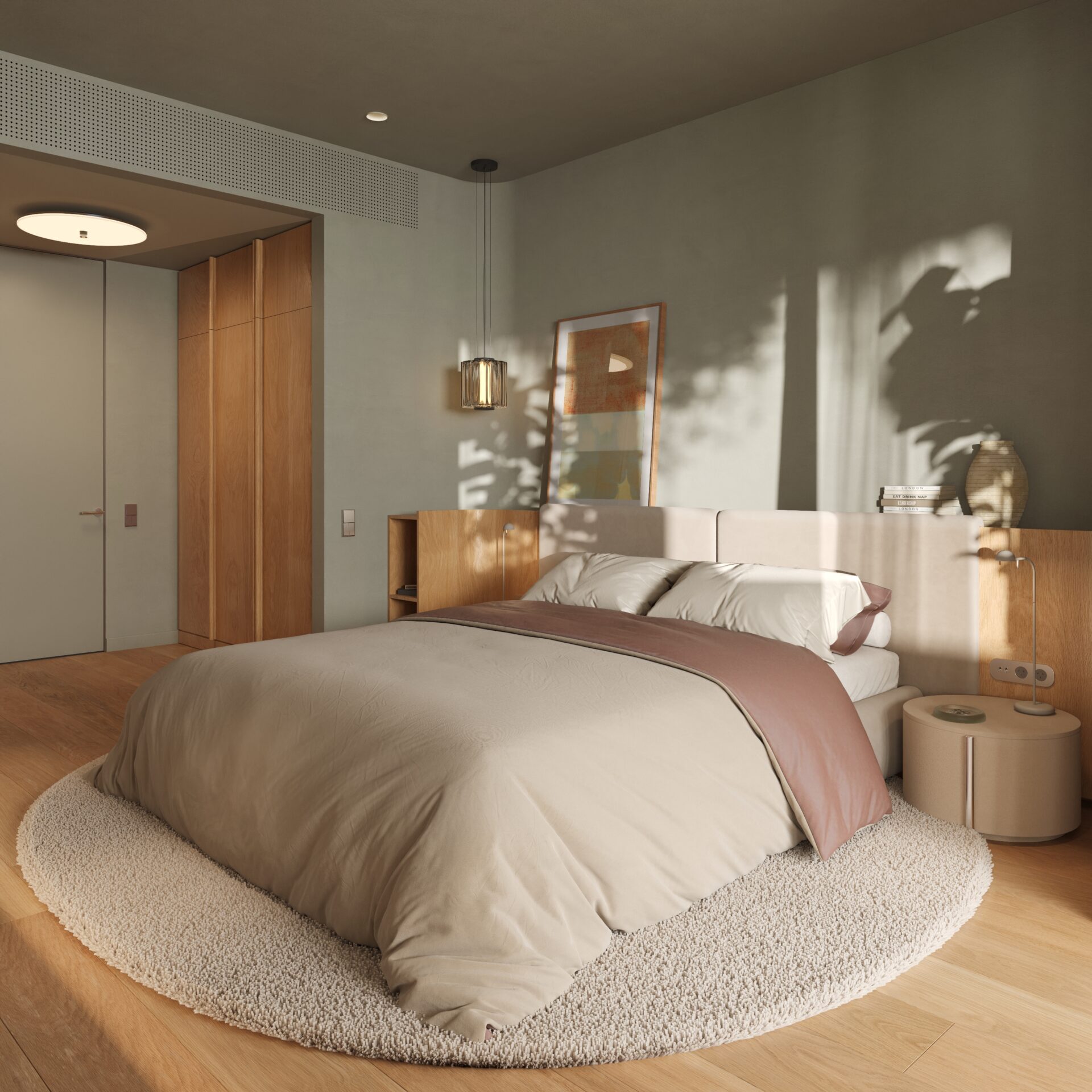 Modern bedroom with a low beige bed, circular shag rug, light wood floors, a nightstand with a lamp, and framed artwork on the wall illuminated by natural light.