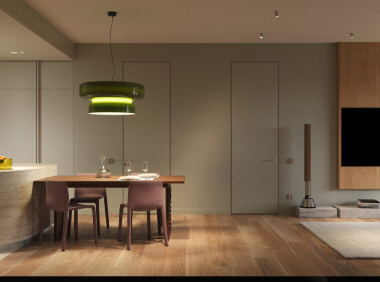 Open-concept living space with a wood kitchen, curved stone island, dining table for four, and a wall-mounted TV in a neutral-toned room.