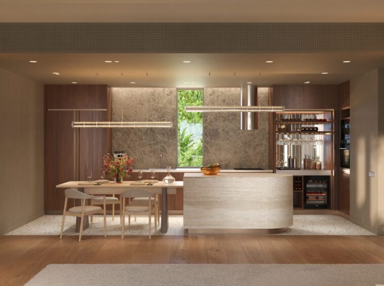 Open-plan kitchen and dining area with an oval island, wooden cabinets, and warm pendant lighting.