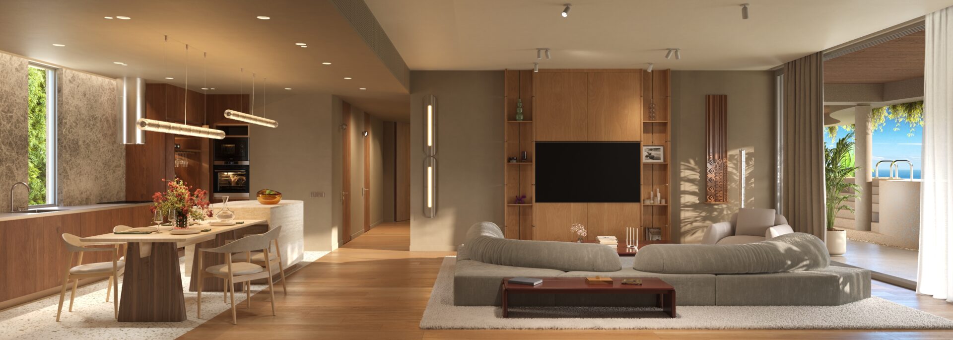 Open-plan living area with a wooden kitchen, round dining table, and a gray sectional facing a wall-mounted TV in a warm, modern apartment, with a balcony seen through large glass doors.
