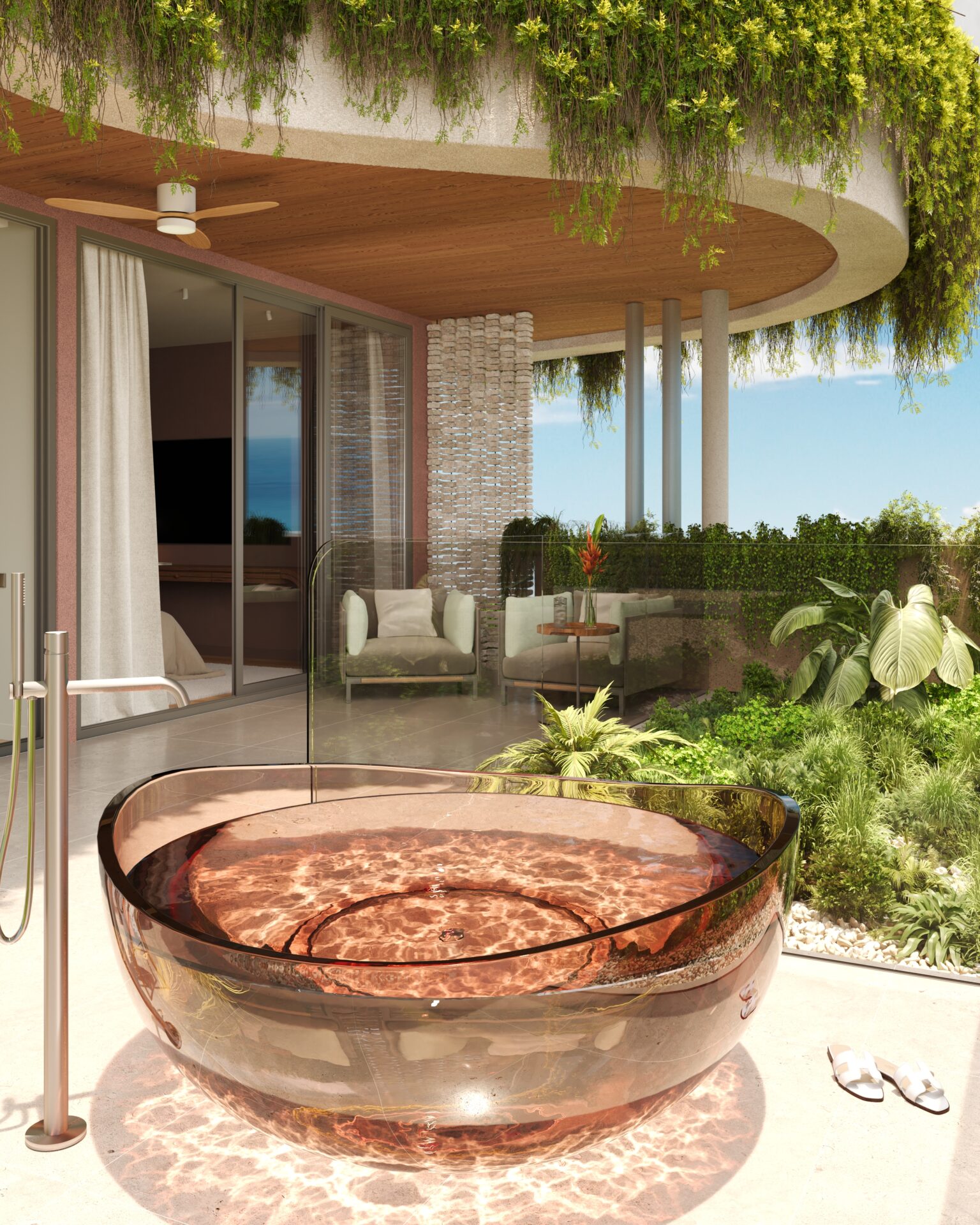 Circular copper hot tub on a sunlit patio with glass railing and lush greenery, overlooking the ocean.