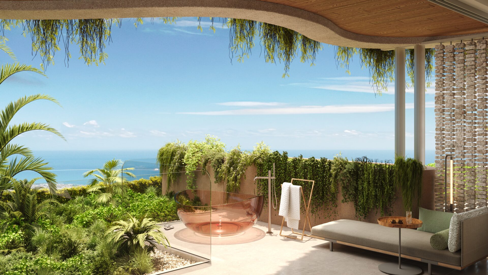 Modern outdoor lounge on a terrace with lush plants, glass railing, and a view of the ocean under a clear blue sky.