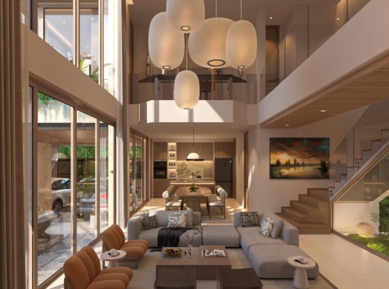 Open-concept living and dining area with a cluster of white oval pendant lights, glass railing, and large windows letting in daylight.
