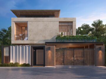 Modern two‑story concrete house with wooden accents, a gated entrance, and greenery along a low wall at the front.