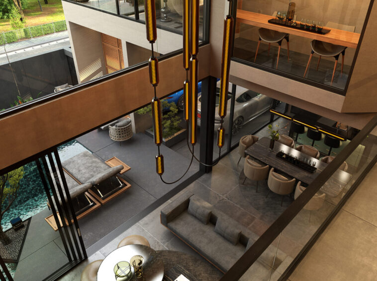 Spacious modern atrium with amber pendant lights, glass railings, and two-level living areas with a dining table and lounge seating.