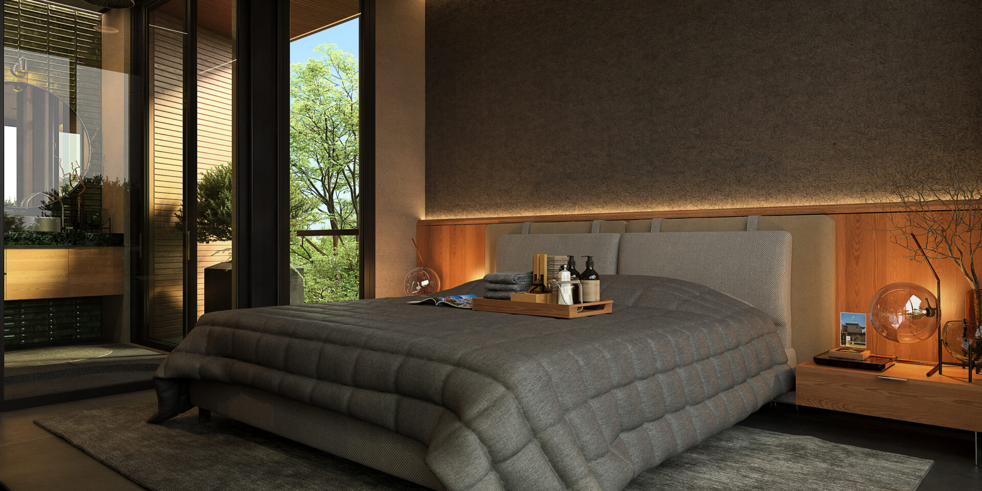 Modern bedroom with a low, quilted gray bed, wooden headboard, and glass doors showing greenery outside.