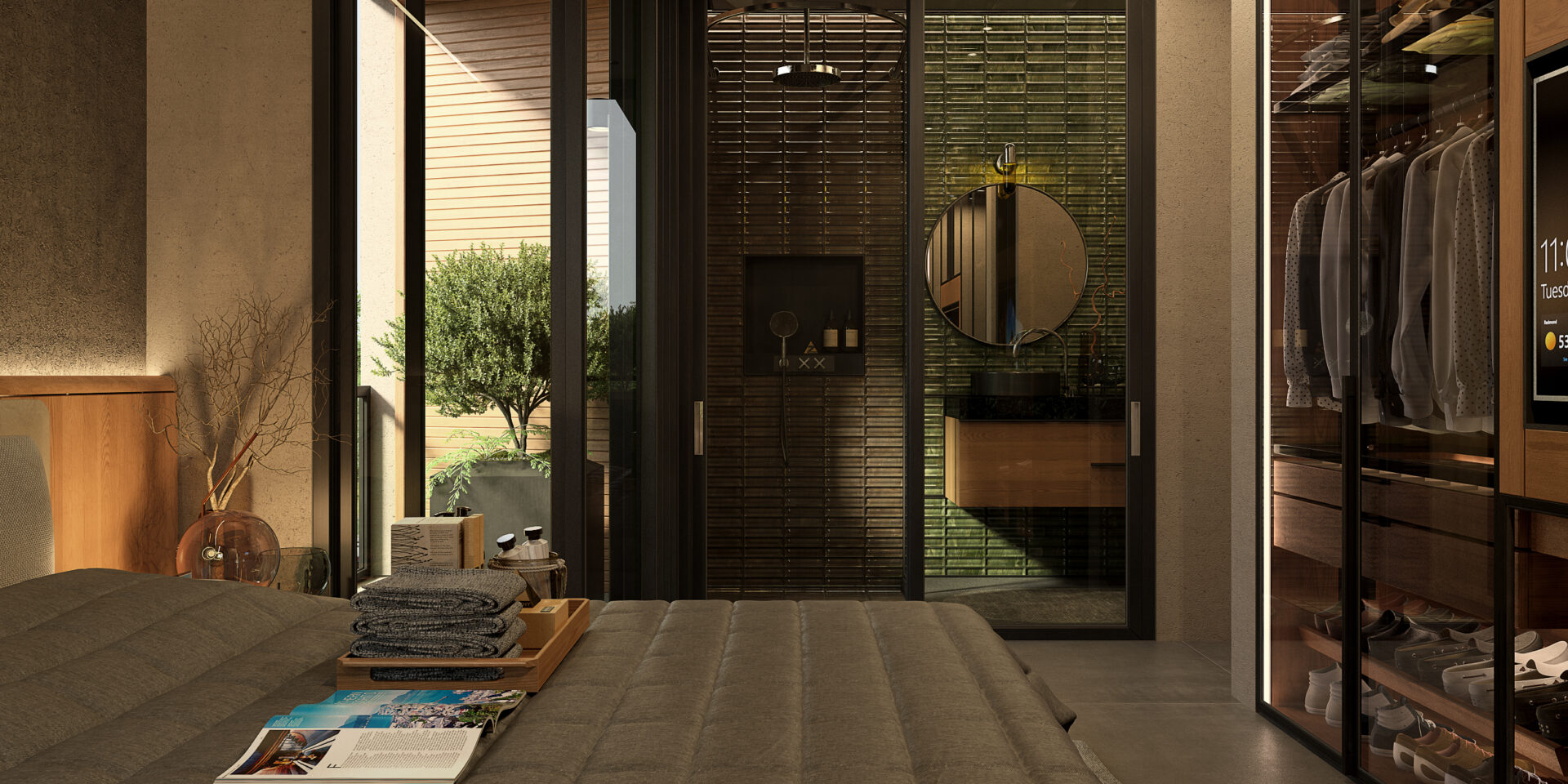 Bedroom with glass-walled en-suite: green tiled bathroom, round mirror, and wooden vanity seen through a doorway on the right side of the room.