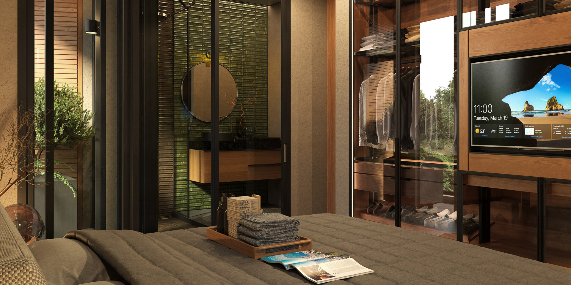 Luxurious bedroom with glass-walled walk-in closet, clothes on racks, and a large flat-screen TV displaying a landscape.