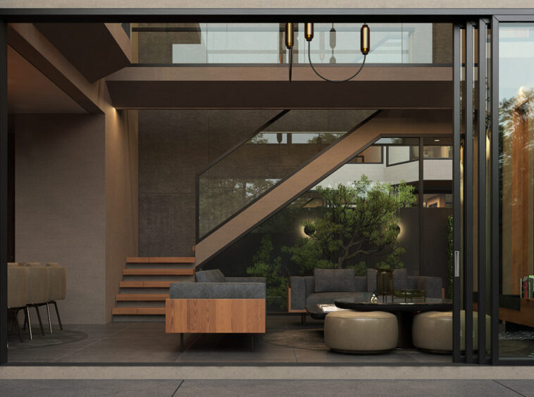 Open-concept living area with a diagonal staircase, glass railings, and greenery, viewed from the doorway.