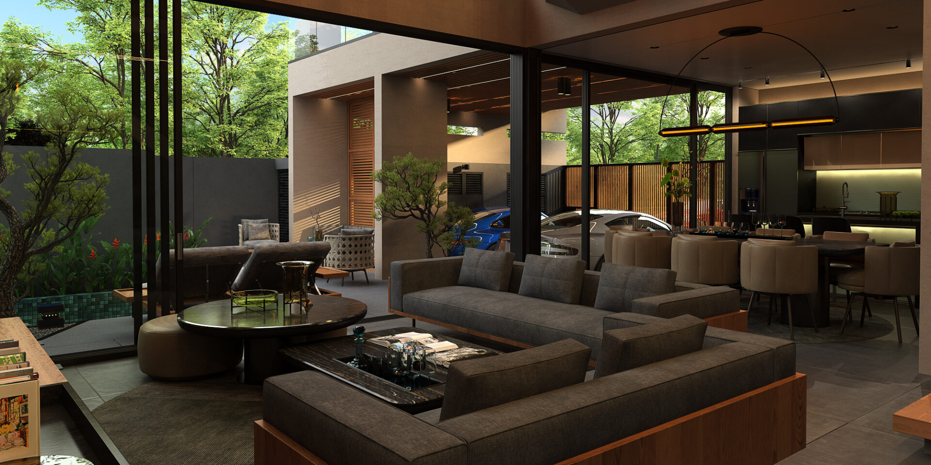Modern open-plan living area with gray sofas, glass walls, and a view of a courtyard and cars outside in a contemporary home.