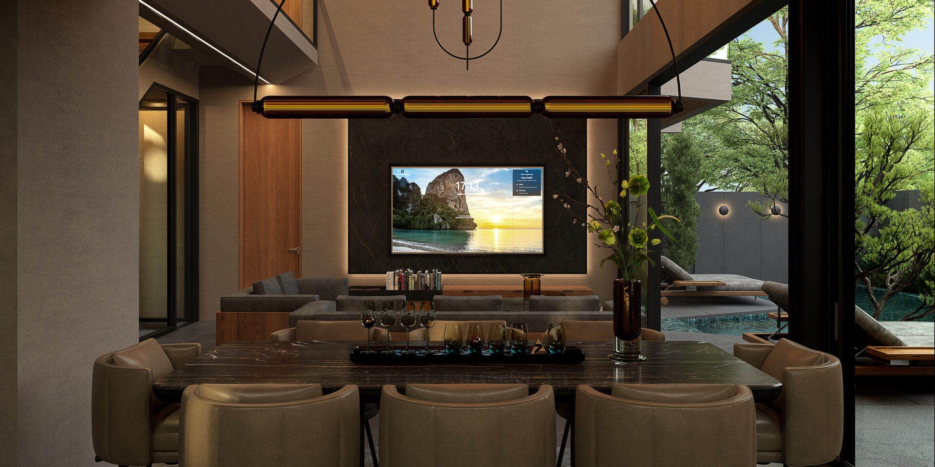 Luxurious living room with a wall-mounted TV on a dark marble backdrop, a long dining table in the foreground, and beige chairs around it, overlooking an outdoor pool and greenery.