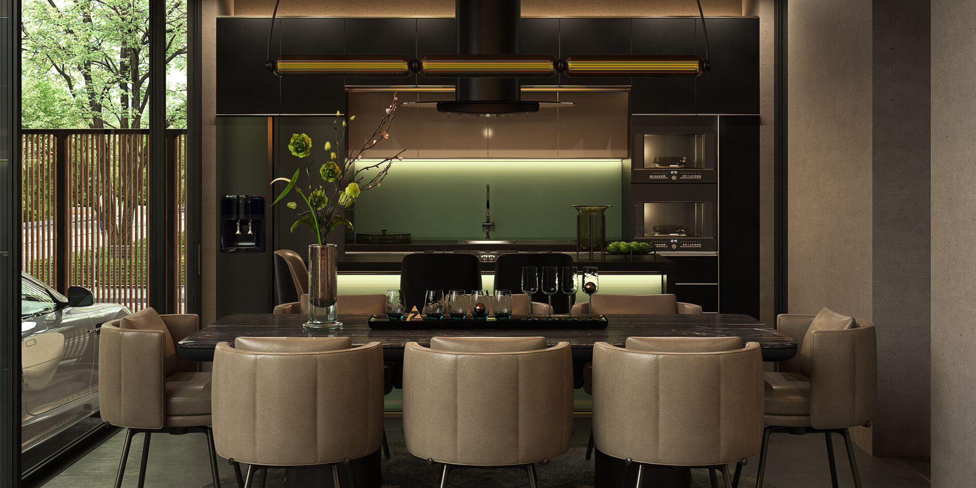 Modern kitchen and dining area with a dark island, green backsplash, and a long table set with glassware and beige chairs surrounding it.