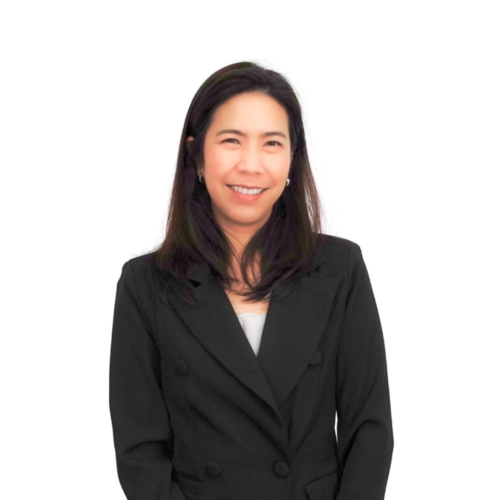 Professional headshot of a smiling woman in a black blazer against a white background.