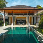 Resort-style villa with an outdoor pool, open living area, and tropical landscaping.
