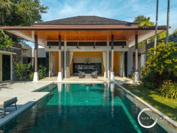 Resort-style villa with an outdoor pool, open living area, and tropical landscaping.